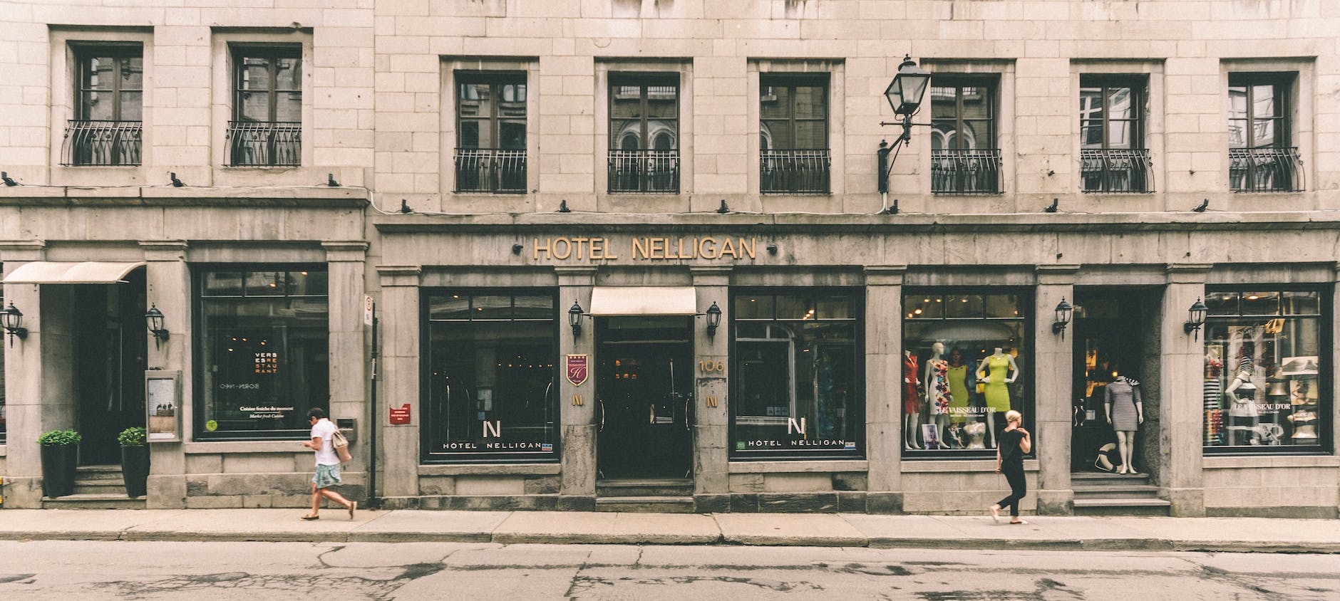people walking on street in front of building with steps that inaccessible
