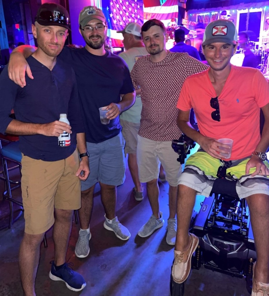 Josh in his power chair, spending time with friends