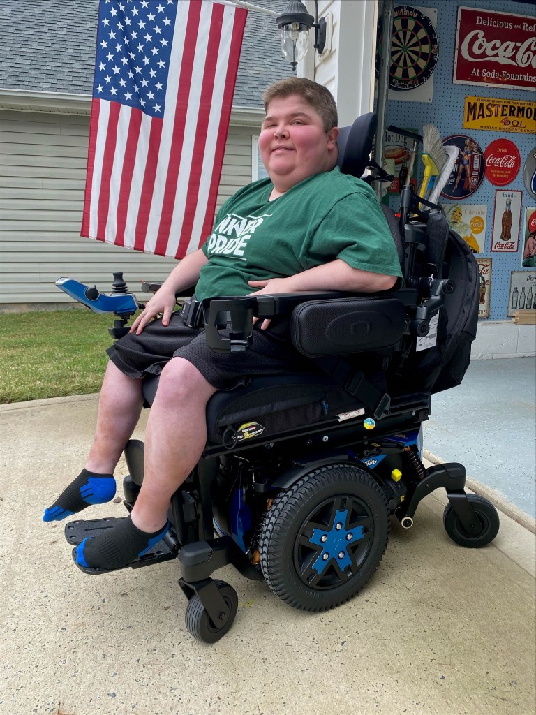 Bryson is in the lowered position in his Quantum power wheelchair