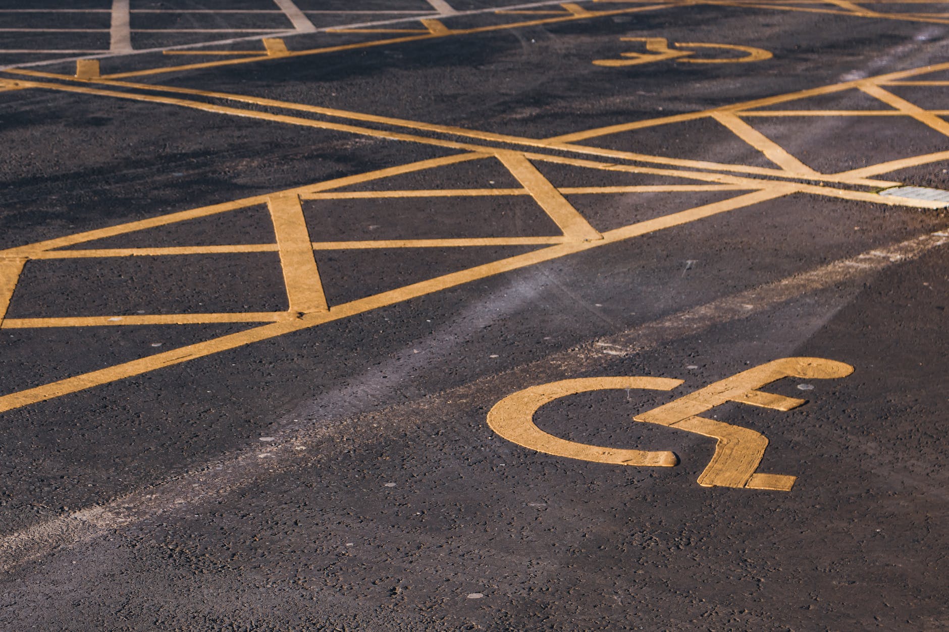 disabled parking signs on asphalt pavement