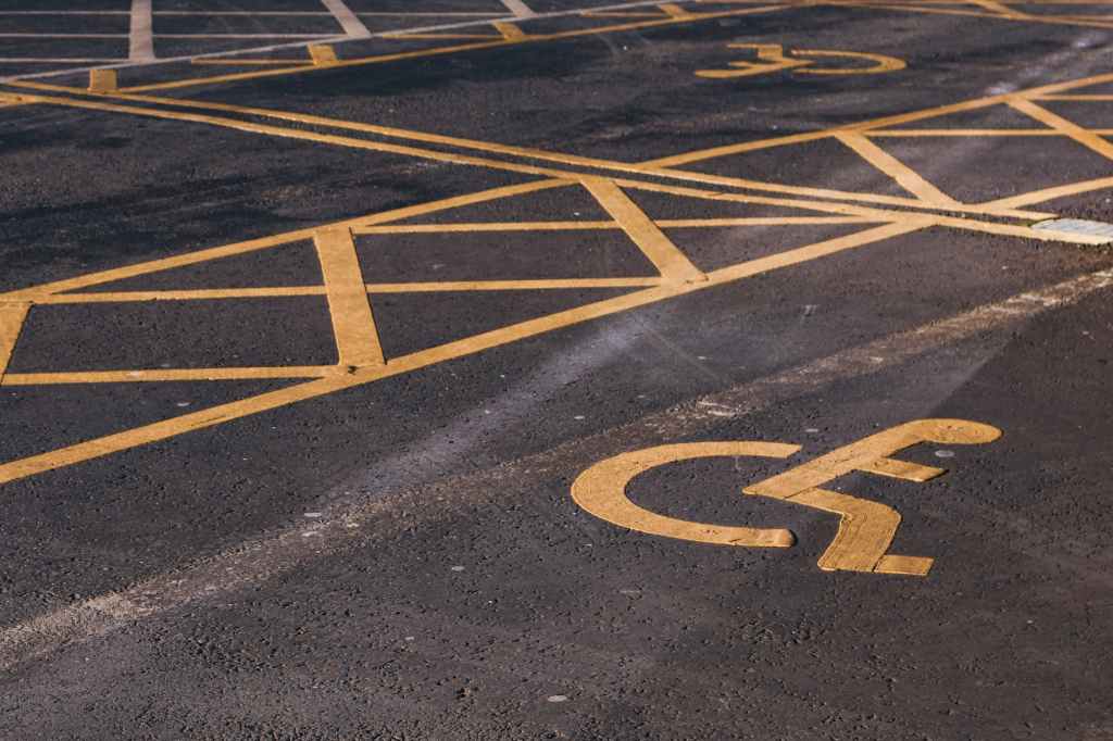 disabled parking signs on asphalt pavement