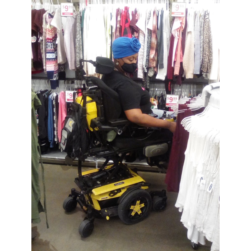 Merlisha shops while elevated at iLevel in her Quantum Power Wheelchair