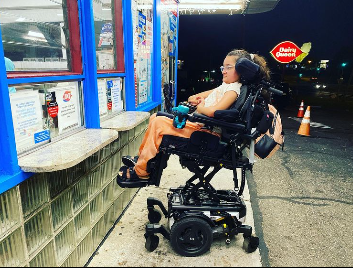 Sakina in her Quantum Power Wheelchair