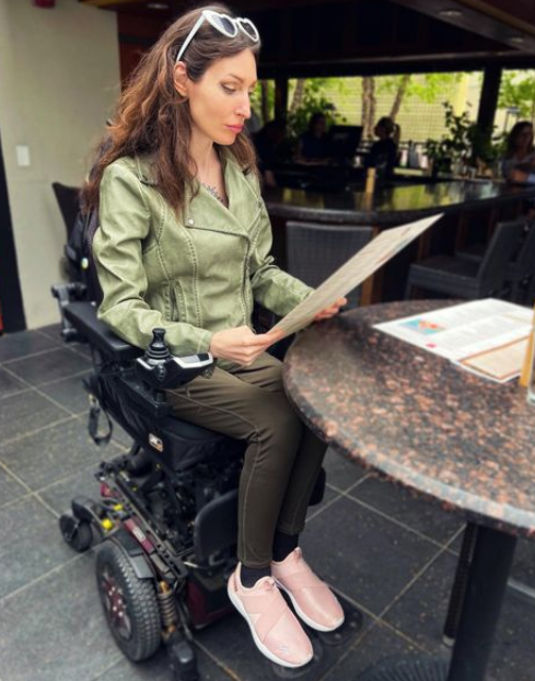 Anomie elevated in her Quantum power wheelchair