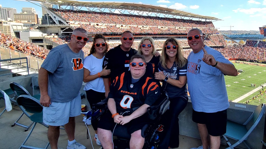 Bryson, in his Quantum power wheelchair, with friends cheering on the Bengals
