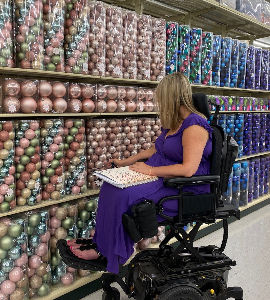 Bliss shops for holiday decor in her Quantum power wheelchair